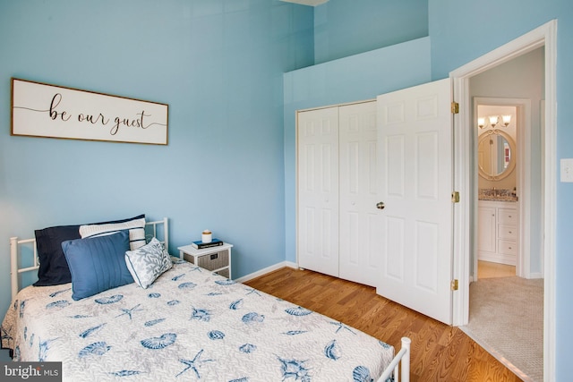 8859 Howland Pl, Bristow, VA 20136 - bedroom with a closet, wood finished floors, and a towering ceiling
