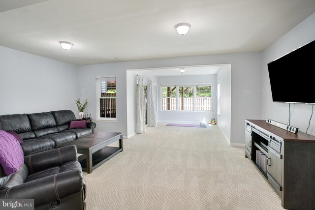 8859 Howland Pl, Bristow, VA 20136 - living room featuring light carpet and baseboards