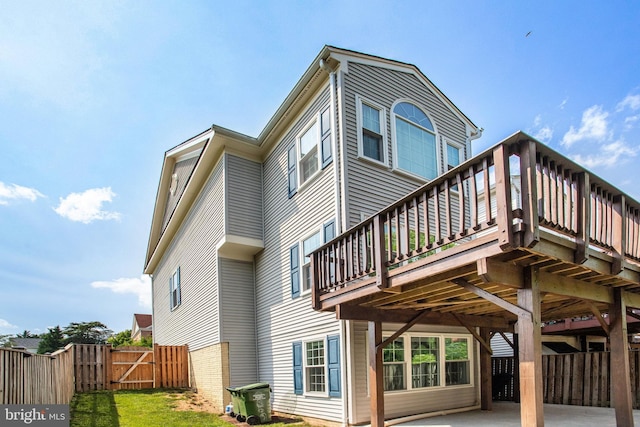 8859 Howland Pl, Bristow, VA 20136 - back of house featuring a deck and a gate