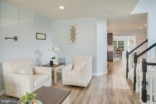8859 Howland Pl, Bristow, VA 20136 - living area with light wood-style flooring, recessed lighting, and stairs