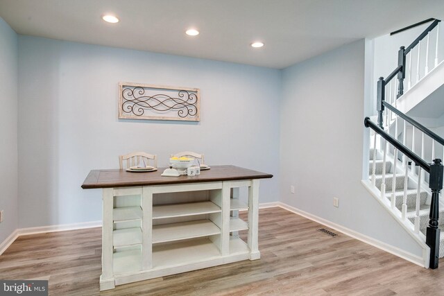 8859 Howland Pl, Bristow, VA 20136 - dining space featuring light wood-type flooring, stairs, and recessed lighting
