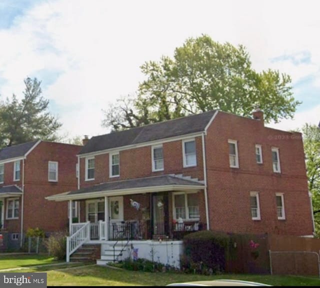 5709 Walther Ave, Baltimore, MD 21206 - multi unit property with covered porch, a chimney, a front yard, and brick siding