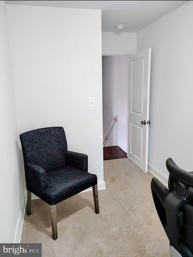 5709 Walther Ave, Baltimore, MD 21206 - living area featuring an upstairs landing, carpet flooring, and baseboards
