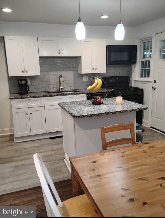 5709 Walther Ave, Baltimore, MD 21206 - kitchen with black appliances, a sink, white cabinetry, wood finished floors, and recessed lighting
