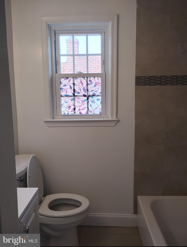 5709 Walther Ave, Baltimore, MD 21206 - bathroom featuring tile patterned flooring, toilet, vanity, a tub, and baseboards