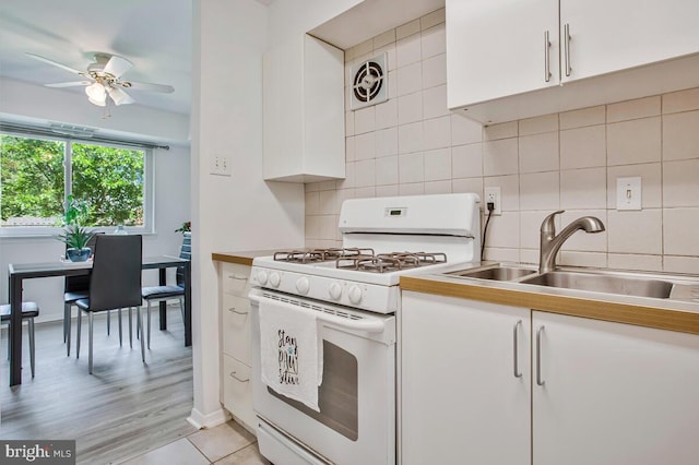 211 Victor Pkwy Unit B, Annapolis, MD 21403 - kitchen with white range with gas stovetop, a sink, white cabinetry, and ceiling fan