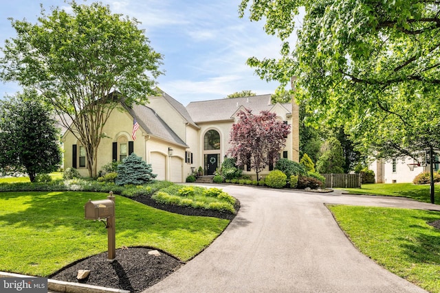 725 Cornerstone Ln, Bryn Mawr, PA 19010 - view of front facade featuring stucco siding, curved driveway, and an attached garage