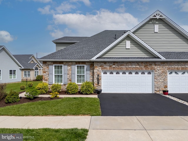 4371 Founders Dr, Center Valley, PA 18034 - view of front of property featuring roof with shingles, stone siding, driveway, and a front lawn