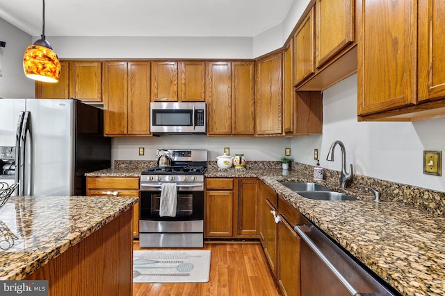 13503 Bannacker Pl, Herndon, VA 20171 - kitchen with stainless steel appliances, light wood-style floors, and brown cabinets
