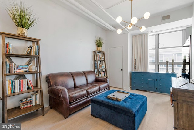 1300 N St NW Unit 817, Washington, DC 20005 - living area with light wood-style floors and a chandelier