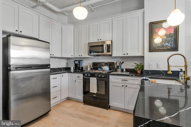 1300 N St NW Unit 817, Washington, DC 20005 - kitchen with stainless steel appliances, a sink, decorative backsplash, and decorative light fixtures