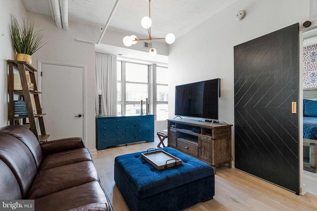 1300 N St NW Unit 817, Washington, DC 20005 - living area with light wood-type flooring and a chandelier