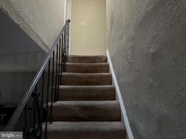 2857 Woodbrook Ave, Baltimore, MD 21217 - staircase featuring a textured wall