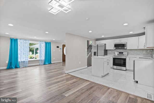 5908 Michael Rd, Waldorf, MD 20601 - kitchen featuring appliances with stainless steel finishes, open floor plan, a center island, light countertops, and white cabinets