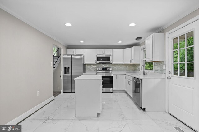 5908 Michael Rd, Waldorf, MD 20601 - kitchen with appliances with stainless steel finishes, a sink, baseboards, a kitchen island, and light countertops