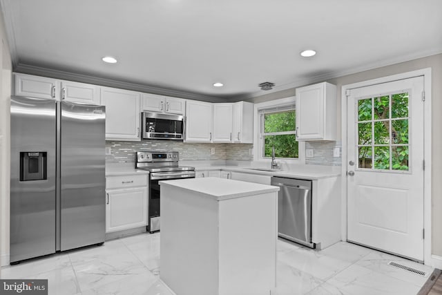 5908 Michael Rd, Waldorf, MD 20601 - kitchen featuring stainless steel appliances, a sink, light marble finish floors, light countertops, and ornamental molding