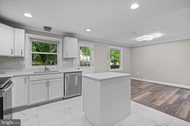 5908 Michael Rd, Waldorf, MD 20601 - kitchen featuring dishwasher, a sink, crown molding, plenty of natural light, and light marble finish floors