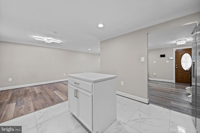 5908 Michael Rd, Waldorf, MD 20601 - kitchen with light marble finish flooring, crown molding, recessed lighting, white cabinets, and baseboards