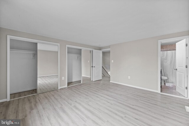 5908 Michael Rd, Waldorf, MD 20601 - unfurnished bedroom with multiple closets, wood finished floors, baseboards, and ensuite bath