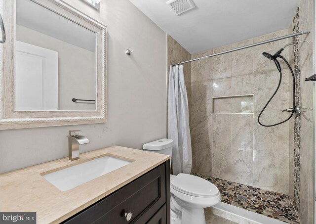 5908 Michael Rd, Waldorf, MD 20601 - full bathroom featuring vanity, tiled shower, and toilet