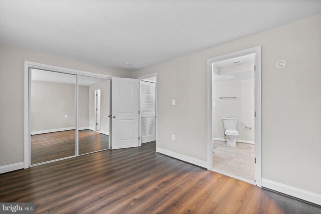 5908 Michael Rd, Waldorf, MD 20601 - unfurnished bedroom featuring a closet, wood finished floors, baseboards, and ensuite bathroom