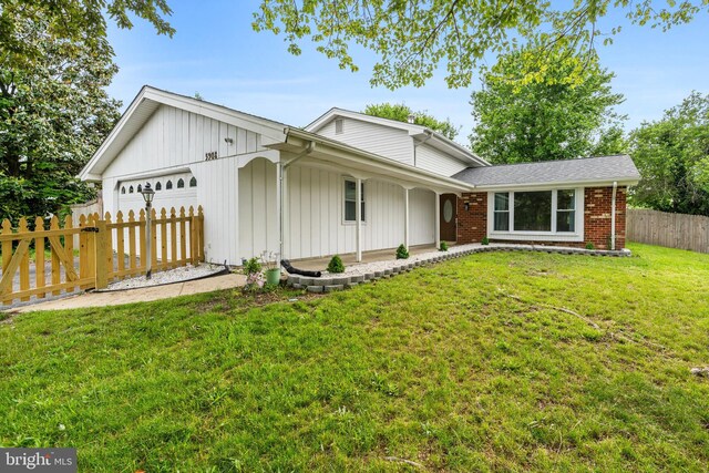 5908 Michael Rd, Waldorf, MD 20601 - view of front facade featuring a garage, brick siding, and covered porch