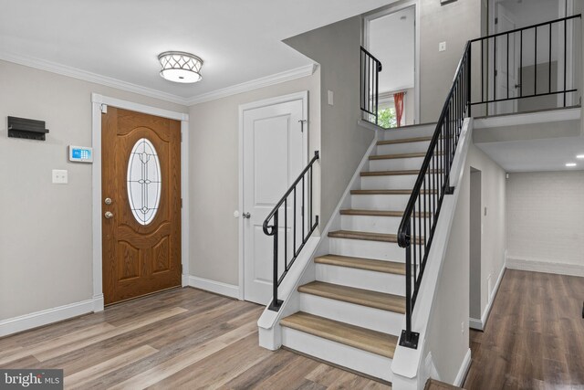 5908 Michael Rd, Waldorf, MD 20601 - entryway with wood finished floors, baseboards, stairs, and ornamental molding