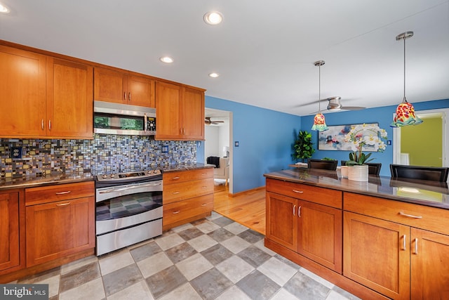 1918 Michael Rd, Waldorf, MD 20601 - kitchen featuring appliances with stainless steel finishes, a ceiling fan, brown cabinets, decorative backsplash, and recessed lighting