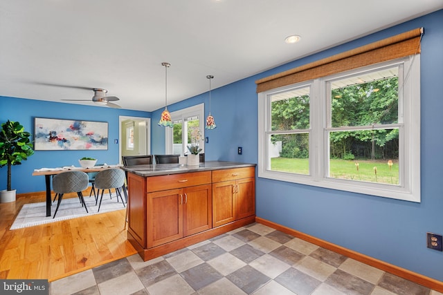1918 Michael Rd, Waldorf, MD 20601 - kitchen featuring a peninsula, brown cabinets, healthy amount of natural light, and baseboards