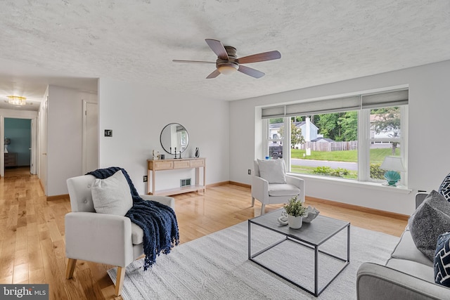 1918 Michael Rd, Waldorf, MD 20601 - living room featuring light wood finished floors, a ceiling fan, baseboards, and a textured ceiling