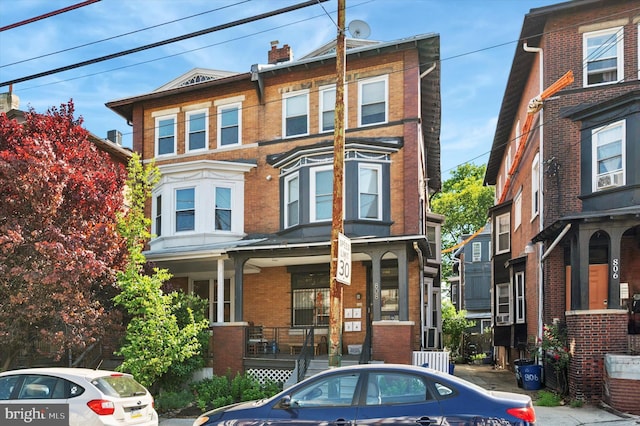 810 S 49th St, Philadelphia, PA 19143 - multi unit property featuring brick siding, covered porch, and a chimney