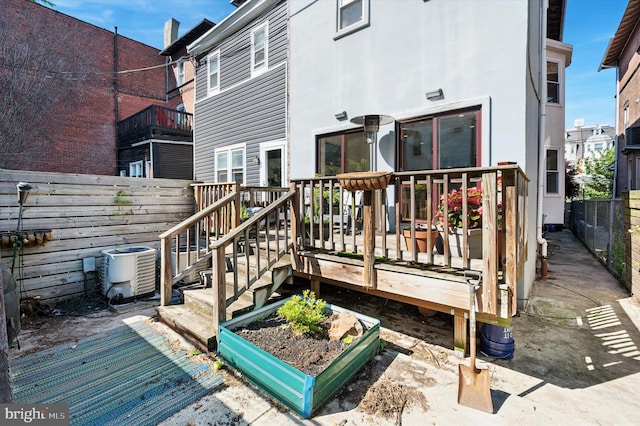 810 S 49th St, Philadelphia, PA 19143 - rear view of property featuring a deck, a fenced backyard, central AC, and stucco siding