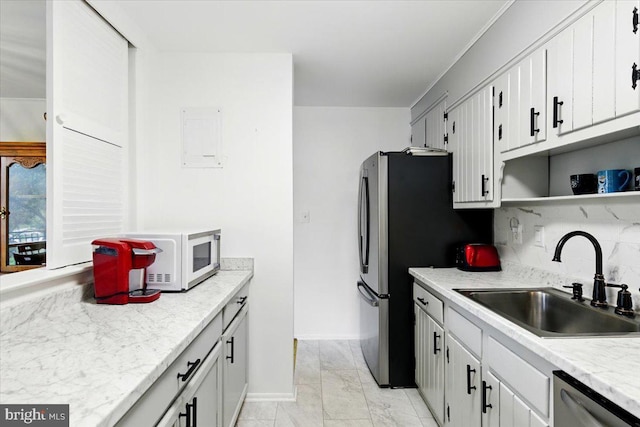 9272 Adelphi Unit 103, Hyattsville, MD 20783 - kitchen with a sink, stainless steel dishwasher, open shelves, light marble finish flooring, and light countertops