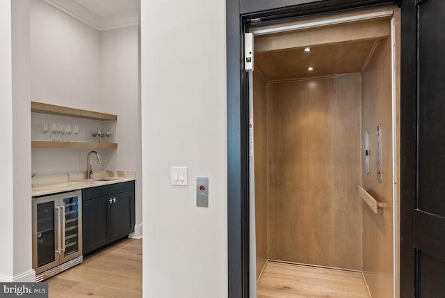 825 Whann Ave, Mclean, VA 22101 - indoor wet bar featuring wine cooler, elevator, crown molding, and light wood finished floors