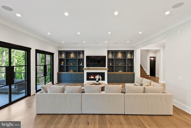 825 Whann Ave, Mclean, VA 22101 - living area featuring recessed lighting, a warm lit fireplace, light wood-style floors, stairway, and crown molding