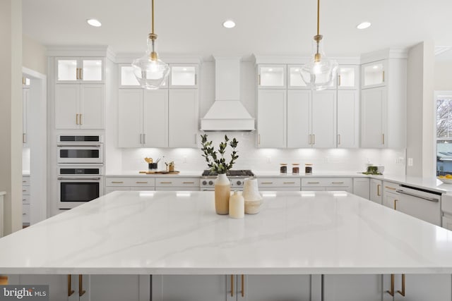 1749 Beulah Rd, Vienna, VA 22182 - kitchen with custom exhaust hood, a large island, white appliances, backsplash, and white cabinetry