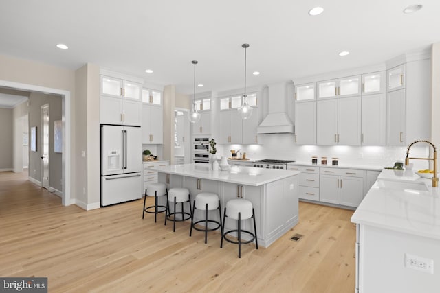 1749 Beulah Rd, Vienna, VA 22182 - kitchen with white appliances, a sink, custom exhaust hood, a center island, and a kitchen bar