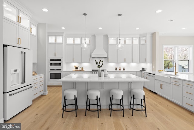 1749 Beulah Rd, Vienna, VA 22182 - kitchen featuring white appliances, premium range hood, a sink, a kitchen island, and light countertops