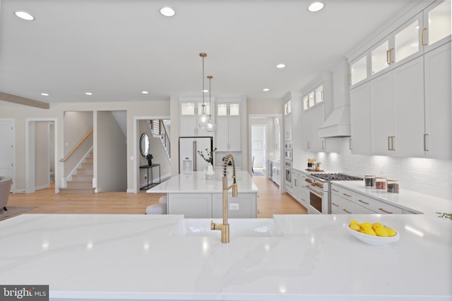 1749 Beulah Rd, Vienna, VA 22182 - kitchen featuring white appliances, tasteful backsplash, recessed lighting, light wood-type flooring, and light stone countertops