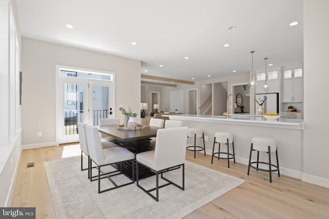 1749 Beulah Rd, Vienna, VA 22182 - dining area with light wood finished floors, recessed lighting, and stairs