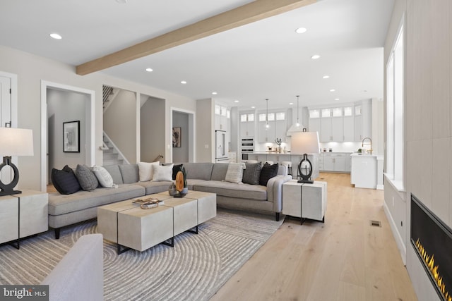 1749 Beulah Rd, Vienna, VA 22182 - living room featuring light wood-style flooring, recessed lighting, beam ceiling, stairway, and healthy amount of natural light