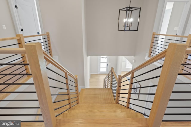 1749 Beulah Rd, Vienna, VA 22182 - staircase featuring a chandelier, wood finished floors, and a high ceiling