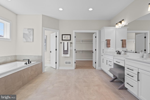 1749 Beulah Rd, Vienna, VA 22182 - bathroom with vanity, a bath, recessed lighting, tile patterned floors, and a walk in closet