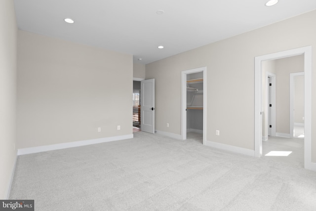 1749 Beulah Rd, Vienna, VA 22182 - unfurnished bedroom featuring light colored carpet, recessed lighting, a walk in closet, baseboards, and a closet