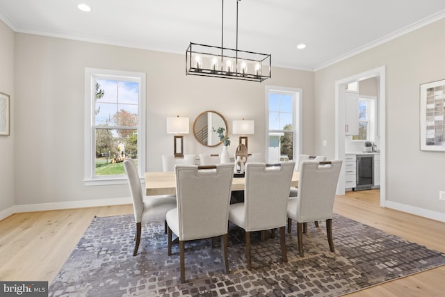 1749 Beulah Rd, Vienna, VA 22182 - dining space with light wood-style flooring, ornamental molding, wine cooler, baseboards, and a chandelier
