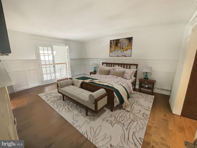 34 Teal Dr, Langhorne, PA 19047 - bedroom featuring a decorative wall, a wainscoted wall, and wood finished floors