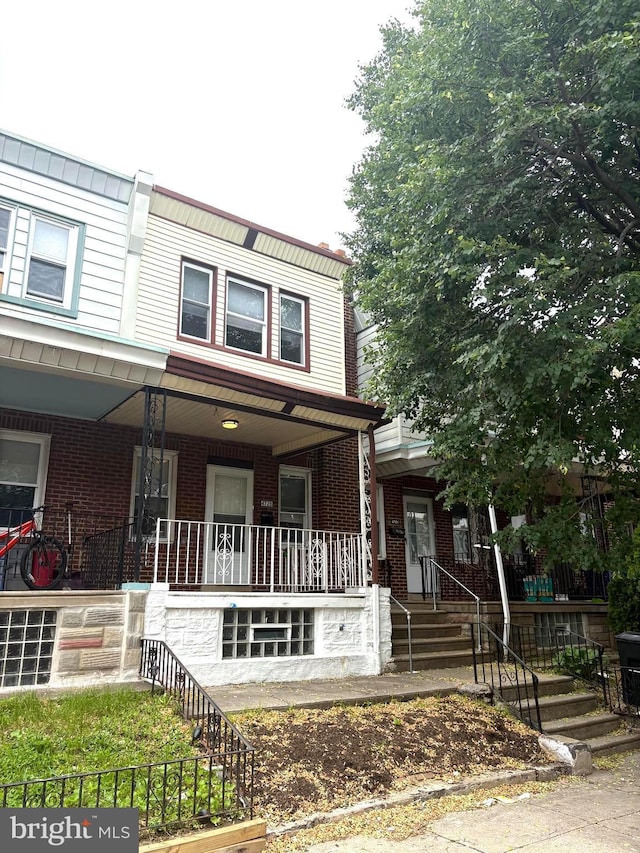 4728 Marple St, Philadelphia, PA 19136 - view of front of house featuring covered porch, brick siding, and stairs