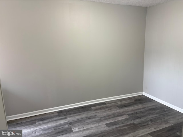 4728 Marple St, Philadelphia, PA 19136 - unfurnished room with dark wood finished floors, baseboards, and a textured ceiling