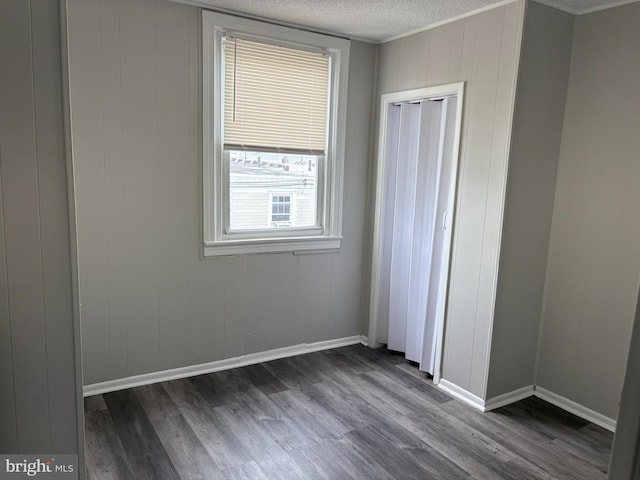 4728 Marple St, Philadelphia, PA 19136 - unfurnished bedroom featuring dark wood finished floors, a textured ceiling, and baseboards