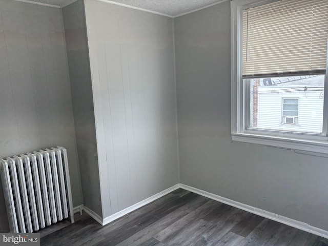 4728 Marple St, Philadelphia, PA 19136 - empty room with radiator, dark wood-style floors, and baseboards